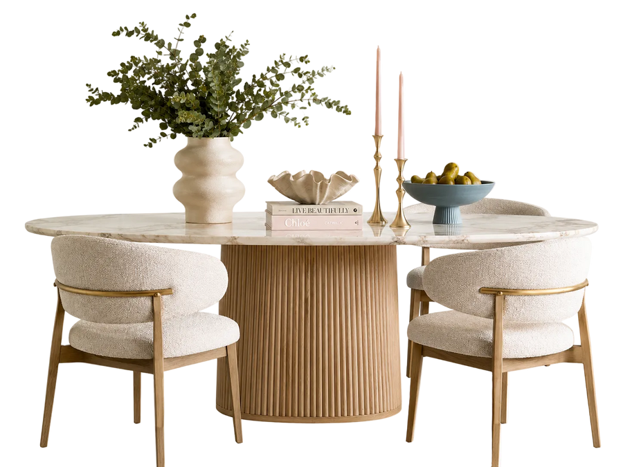 Dining table with chairs, decorative items, and a vase on a white background