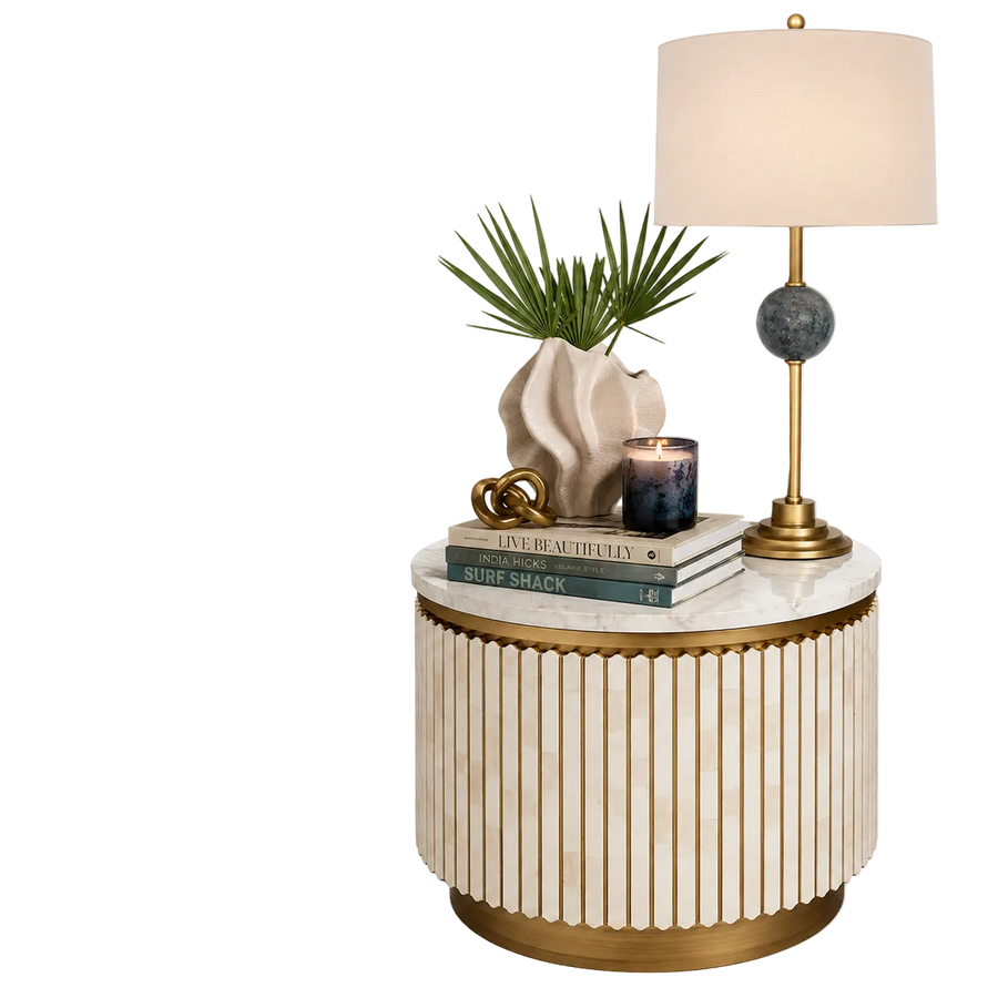 Decorative side table with lamp, books, and plant on a white background
